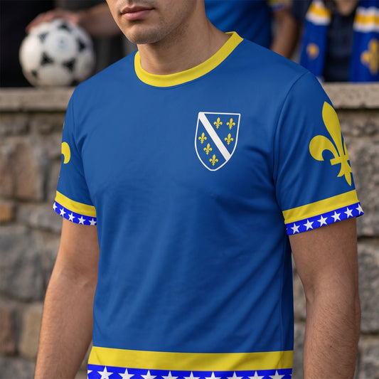 Close-up of Bosnia football jersey showcasing detailed all-over print of golden lily and national colors on front.